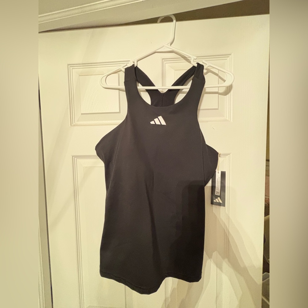 New with tags black adidas tank top. Never worn. Size large - women’s.